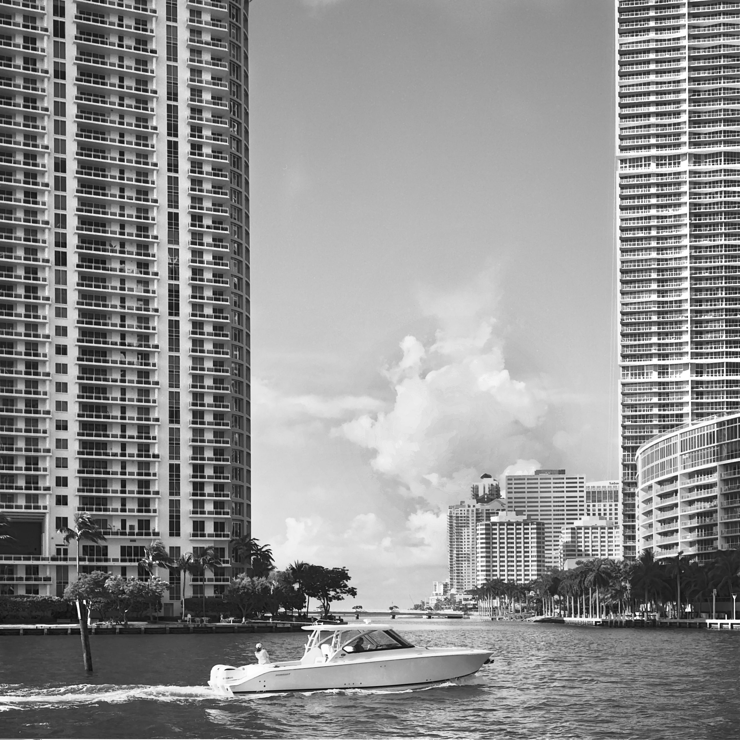 Appartment buildings and a recreational boat on the Miami River, Florida. Captured on Film